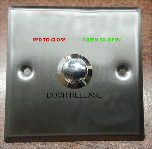 Square stainless steel door release switch marked red to close and green to open