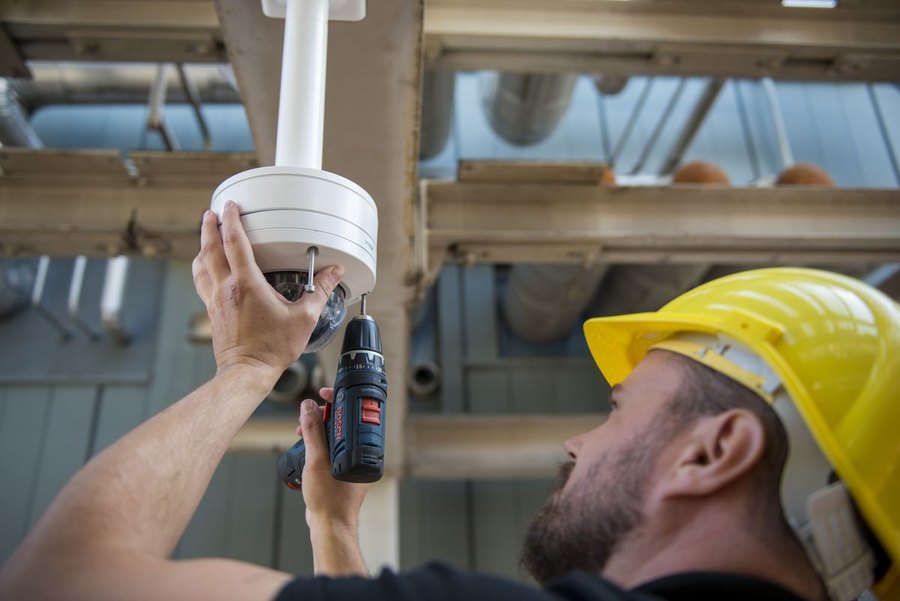 Technician installing a dome camera